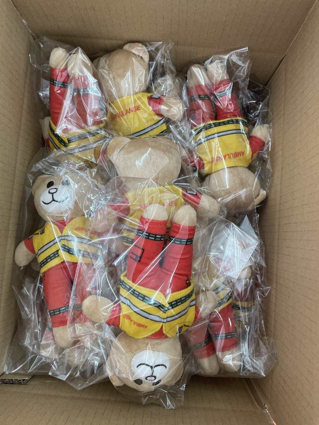 Ambulansebamsen mass production — full box of bears individually wrapped