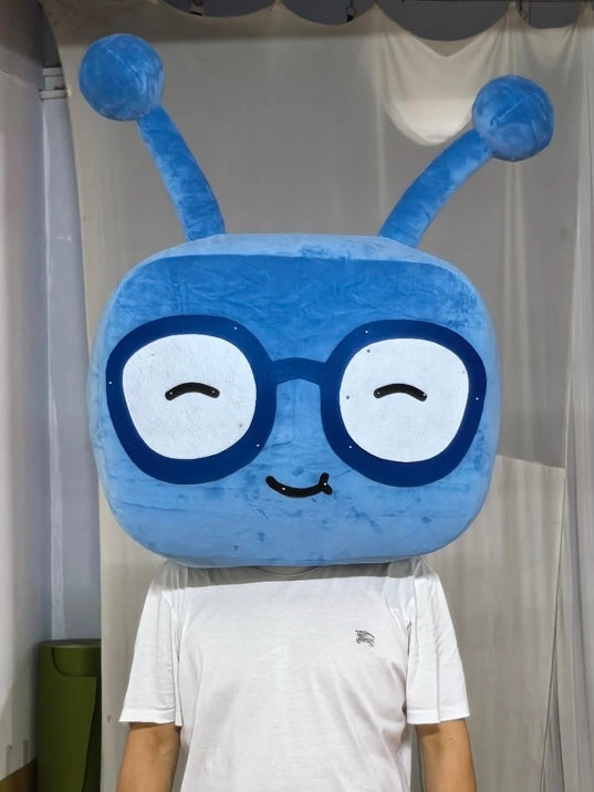 Coddy — blue alien mascot head costume with glasses and antennae