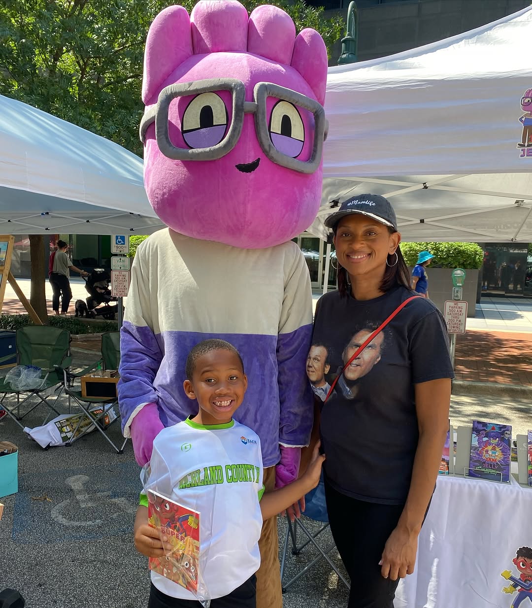 Pink mascot with glasses at a community event — custom mascot by JollyAnime