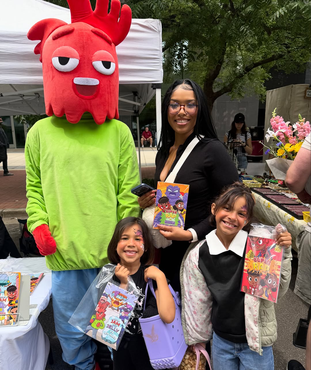 Red monster mascot costume at a fan event with children — custom mascot character by JollyAnime